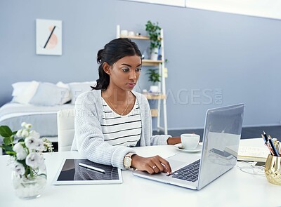 Buy stock photo Cropped shot of an attractive young woman working at home