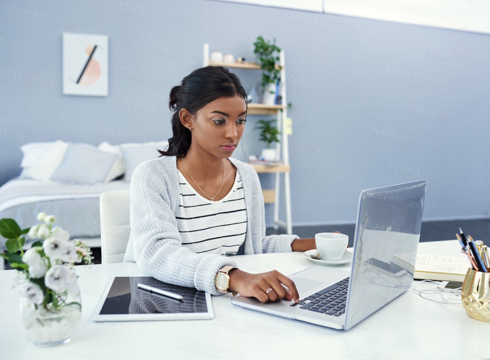 Buy stock photo Cropped shot of an attractive young woman working at home