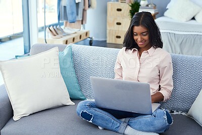 Buy stock photo Laptop, typing and woman on sofa in home for freelance creative journalism startup business. Technology, research and Indian female writer work on online project with computer in living room at house