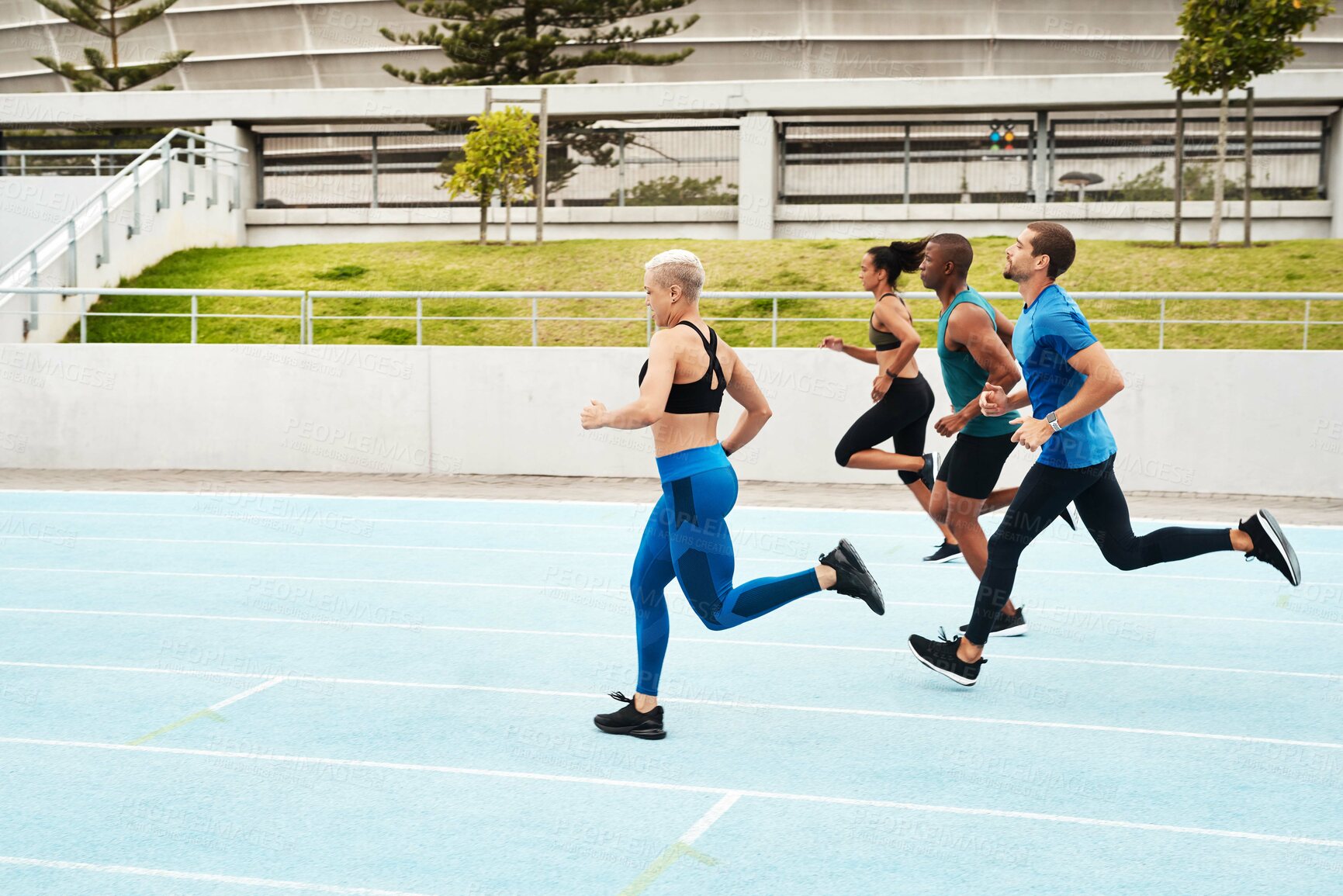 Buy stock photo Group, people and running in stadium for workout or sport on track, training or exercise for wellness. Team, athlete and arena with runner for freedom or health, commitment and strong with cardio