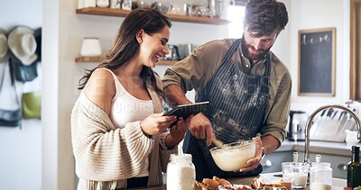 Buy stock photo Couple, people and happy with tablet for baking recipe, ingredients and menu in kitchen at home. Relationship, smile and learning or teaching for dinner with love, support and care for bonding