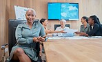 Confident, powerful african american businesswoman in a meeting with her colleagues holding a wireless tablet. Young business professional in her office with her colleagues in collaborating 