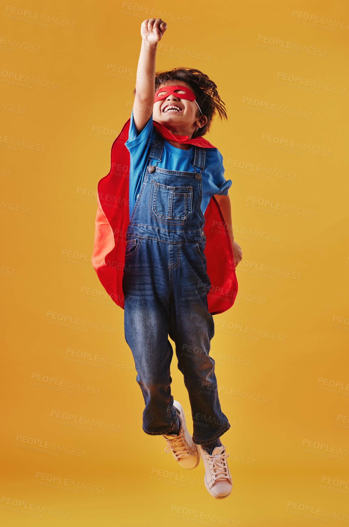 Buy stock photo Boy, flying and superhero costume on studio background, confident and playing fantasy game. Male person, child and character to protect or serve justice, hero courage and proud fighter for power
