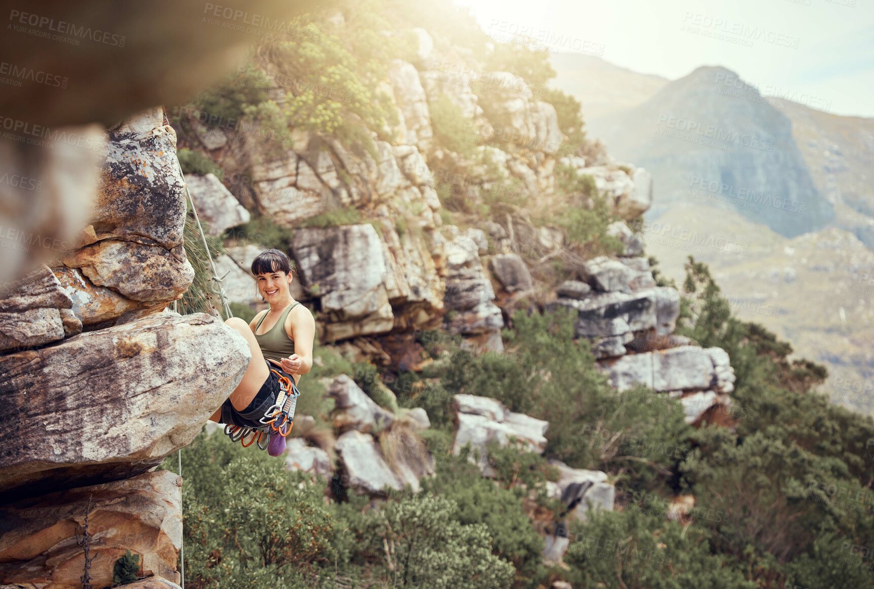 Buy stock photo Mountain, rock climbing and sport with a sports woman and climber abseiling outdoor in nature. Fitness, exercise and health with a strong female athlete training or in a workout in the mountains