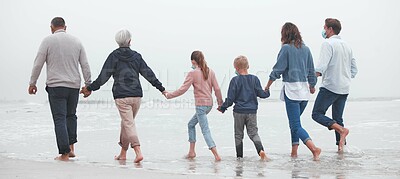 Buy stock photo Big family, holding hands and walking on beach for vacation or quality bonding time together in nature. Hand of parents, grandparents and kids enjoying travel, freedom and family fun in ocean water
