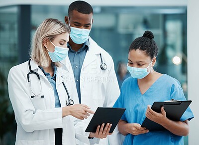 Buy stock photo Doctor, tablet and covid team for healthcare, research or diagnosis in collaboration together at the hospital. Diverse group of medical professionals wearing masks looking at touchscreen in clinic