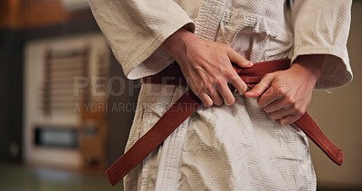 Buy stock photo Person, hands and red belt for karate with exercise, ready and prepare for training in Japan studio. Man, martial arts and professional fighter in dojo for sport, expertise and sensei in self defense