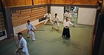 Dojo, group class and Aikido training with wood sword Japanese martial arts and fight exercise in wellness studio. Learning, master and bamboo weapon with people and strike practice for defence
