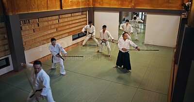Buy stock photo Dojo, group class and Aikido training with wood sword Japanese martial arts and fight exercise in wellness studio. Learning, master and bamboo weapon with people and strike practice for defence