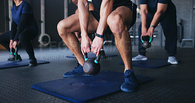 Buy stock photo Fitness, kettle bell and hands of people in gym squat for training, exercise or muscle workout. Sports, health club and trainer with group with weights for wellness, strength or bodybuilder challenge