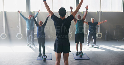 Buy stock photo Personal trainer, senior people and stretching at gym with workout, guide and teaching for fitness. Coach, group and warm up at class for training, learning or exercise at wellness club in retirement