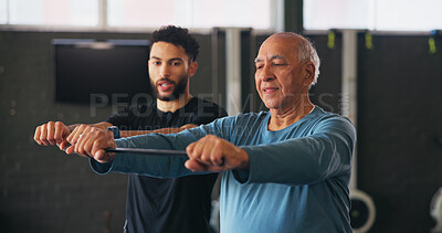 Buy stock photo Personal trainer, senior man and resistance band at gym with workout, guide or teaching for fitness. Coach, help and strong at class for training, learning or exercise at wellness club in retirement
