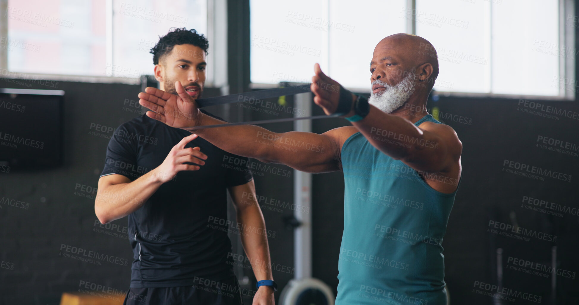 Buy stock photo Personal trainer, senior man and resistance band for fitness with workout, guide or teaching at gym. Coach, help and strong at class for training, learning or exercise at wellness club in retirement