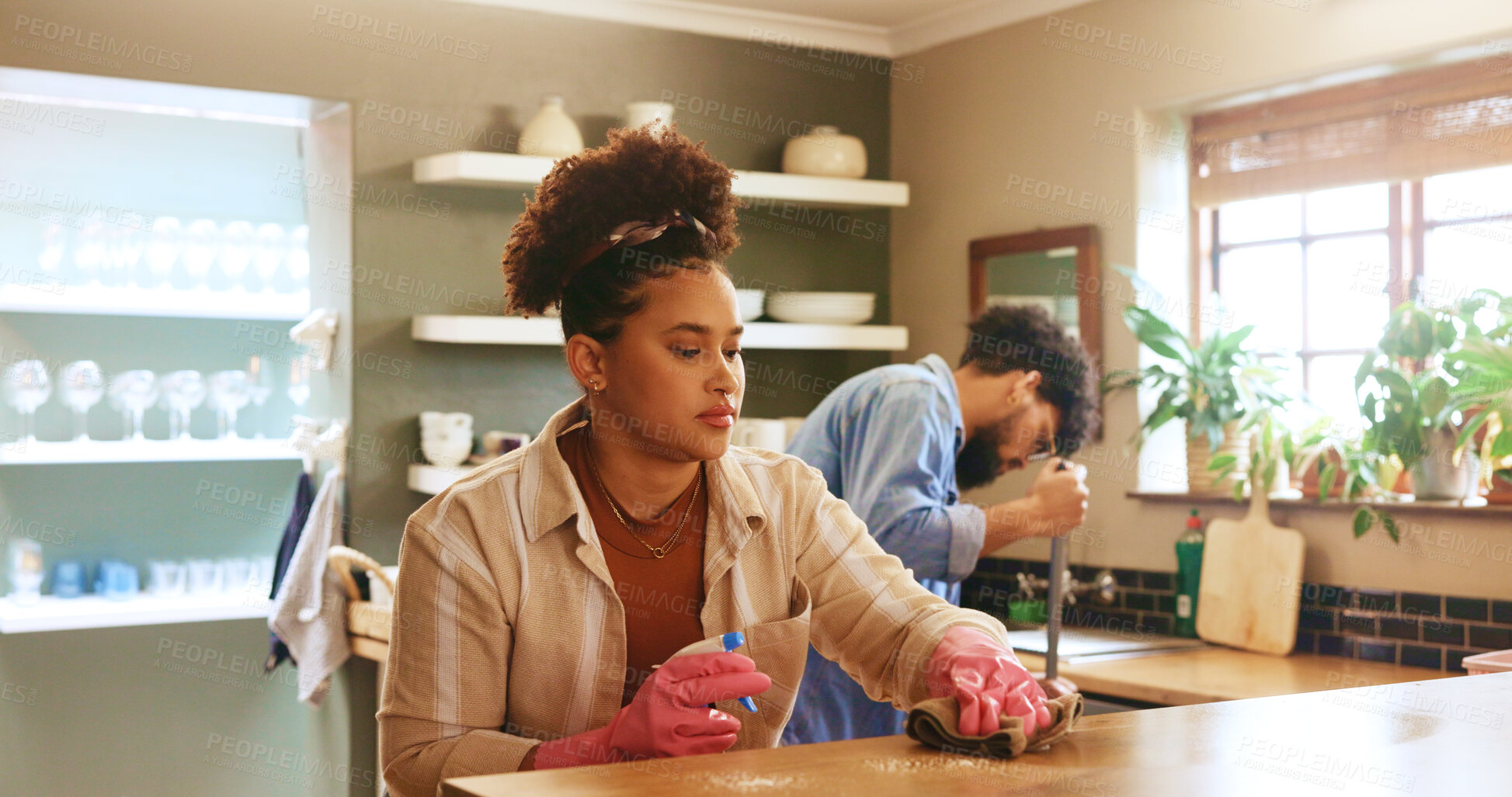 Buy stock photo Woman, cloth and cleaning with spray in kitchen at home with partner, gloves or routine in morning. Couple, relationship and ppe with chemical for bacteria, germs and dirt with shine at apartment