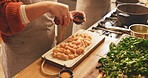 Food, hands and seasoning with person in kitchen of home for flavor or meal preparation. Chicken, cooking or spice and chef in apartment with ingredients or recipe for diet, health and nutrition