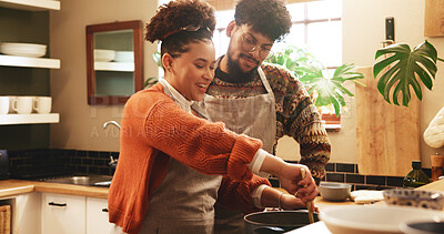 Buy stock photo Couple, woman and cooking in kitchen with support for dinner preparation, healthy meal and bonding. Happy, people and help with food recipe in home for nutrition, marriage and relationship connection