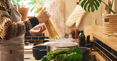Buy stock photo Cooking, hands and spaghetti with person in kitchen of home for boiling or meal preparation. Food, gas stove or pasta and chef in apartment with ingredients or recipe for diet, health and nutrition
