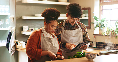Buy stock photo Couple, tablet and cooking in kitchen with search for recipe, video or guide for meal prep in home. People, man and woman with digital touchscreen, app or partner for food, nutrition or diet in house