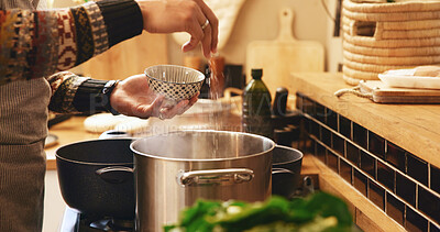 Buy stock photo Cooking, hands and seasoning with person in kitchen of home for flavor or meal preparation. Food, pot or stove and chef in apartment with ingredients or recipe for diet, health and nutrition