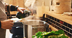 Cooking, hands and pouring with person in kitchen of home for flavor or meal preparation. Food, pot or stove and chef in apartment with vegetable oil or recipe for diet, health and nutrition
