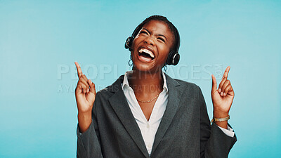 Buy stock photo Pointing up, customer support or black woman in studio for news, virtual help or contact. Blue background, mockup space or happy business person with headset for CRM service or online announcement
