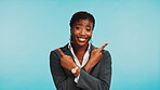 Portrait, business or black woman in studio, pointing or job opportunity on blue background. African person, model or employee with hand gesture, coming soon or about us with space, smile or branding