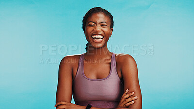 Buy stock photo Black woman, laughing or athlete in studio for fitness, humor or health benefits on blue background. Arms crossed, funny joke or happy African girl model with smile for sports exercise or workout