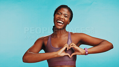 Buy stock photo Studio, black woman and fitness with hands for heart, support and expression of love for wellness. Space, female person and excited with emoji sign for kindness, exercise or health by blue background