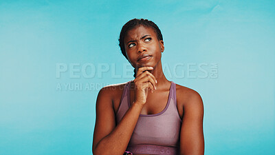 Buy stock photo Fitness, thinking and black woman in studio planning gym workout, weight loss or wellness schedule. Ideas, benefits and athlete girl with inspiration, choice or decision on blue background and space
