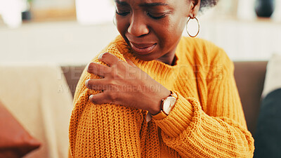 Buy stock photo Hands, woman and shoulder pain on couch at house for discomfort, joint inflammation and fibromyalgia. African person, cramps and muscle tension of arthritis, posture injury and strain of arm fracture