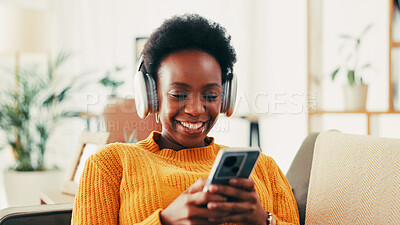 Buy stock photo Home, sofa and black woman with smartphone for music, streaming online and podcast for motivation. House, female person and relax with mobile for application, audio track and headphone for listening