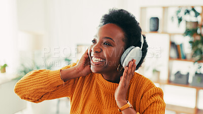 Buy stock photo Black woman, smile and headphones in home with music for audio, radio and hearing podcast on sofa. Happy african person relax for streaming sound, multimedia and online subscription in living room