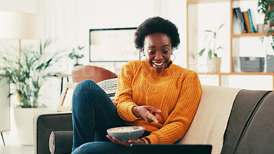 Buy stock photo Black woman, laptop and movie on couch with popcorn, happy and point with comedy in home. Person, relax and computer with snack, film and subscription for streaming on sofa in living room at house