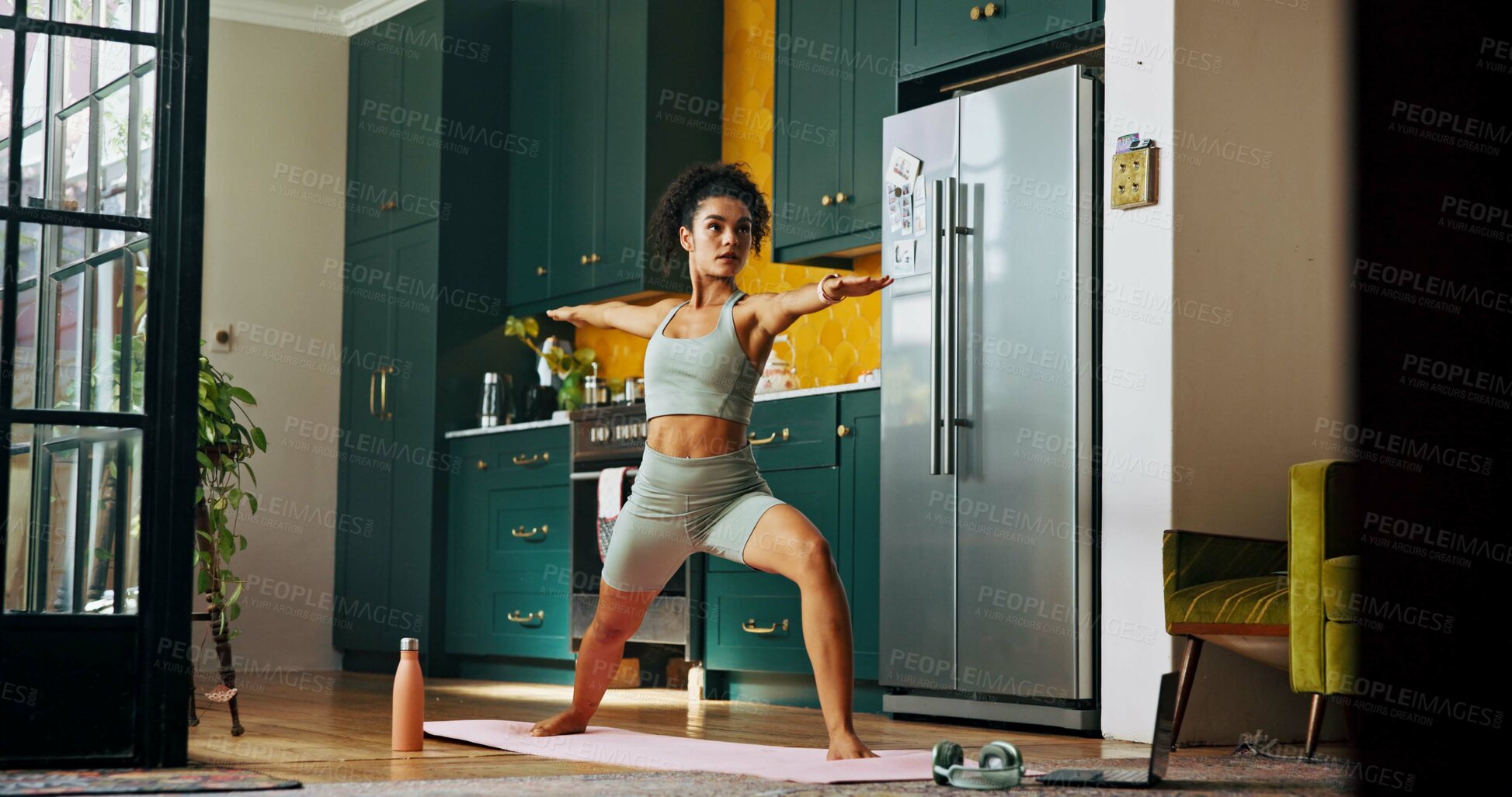 Buy stock photo Woman, yoga and warrior pose in home with laptop for online course, exercise and wellness in kitchen. Girl, person and start routine for health, fitness or stretching with balance in morning at house