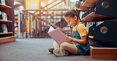 Buy stock photo Girl, kid and reading book in school, relax and smile with fantasy, information and learning. Academic growth, student and child development with education, storytelling and novel with vocabulary