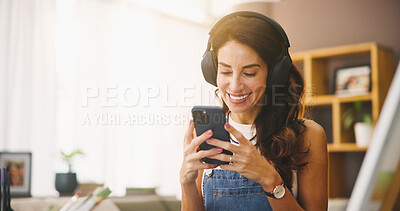 Buy stock photo Home, painter and woman with cellphone, headphones and smile with social media. Mature person, apartment and artist with audio, listening to music and podcast for creative project, app and funny meme