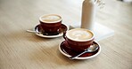 Cafe, drinks and coffee on counter for serving caffeine beverage, espresso and latte art. Hospitality, small business and cappuccino with foam in mug on table for restaurant, diner and service