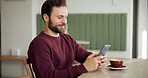 Man, smile and phone in cafe for message, social media or typing in texting app. Male customer, coffee and cellphone in restaurant for connectivity, communication or online dating site for networking