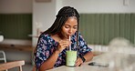 Healthy, green smoothie and woman in cafe, diet and relax with breakfast, nutrition and organic cocktail. African person, customer and girl with drink, wellness and matcha with vegan coffee shop