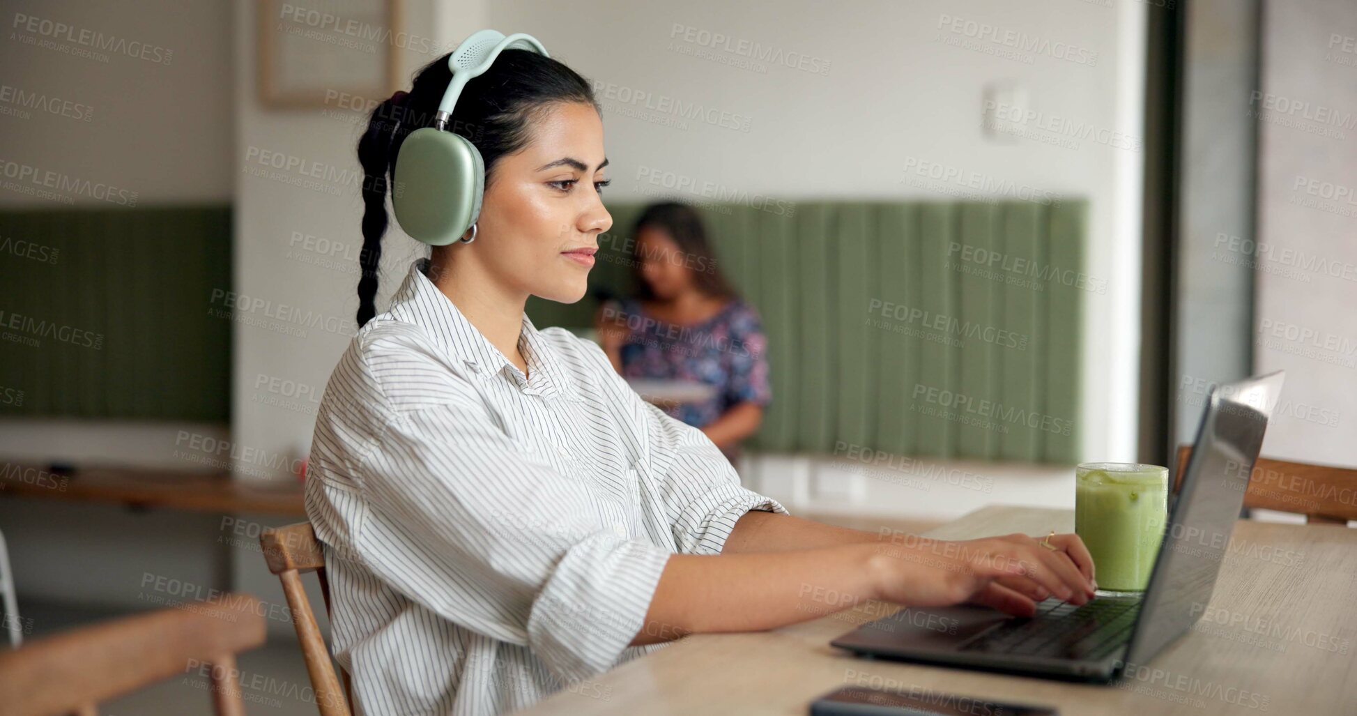 Buy stock photo Happy woman, typing and laptop with headphones at cafe for remote work, email or copywriting. Female person, customer or freelancer on computer for writing, journalism or communication at coffee shop