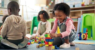 Buy stock photo Education, child and playing with building blocks in classroom for creative activity, development or learning. Happy, girl student or stack toys at kindergarten for gross motor skills or coordination