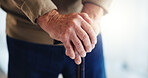 Walking stick, hands and senior man in home for help, support and mobility assistance. Retirement, health and closeup of person with disability with cane for wellness, injury recovery and balance