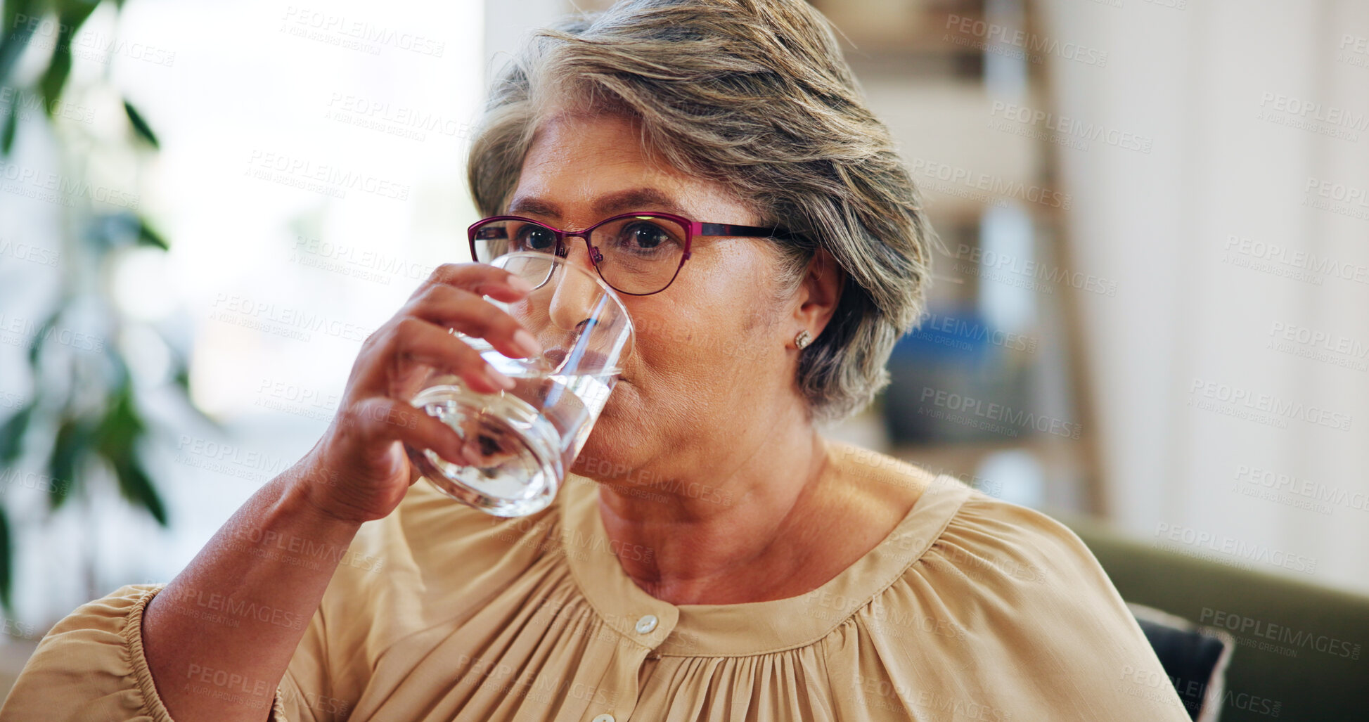 Buy stock photo Drinking, water and senior woman in nursing home, thirsty and liquid for organ function or hydration. Temperature regulation, nutrition and elderly person with fluid to detox, healthy and living room
