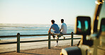 Men, back and friends at beach for break with bonding, space and support outdoor. Sunset, road trip and people by wood fence, travel or vacation to relax with connection in nature with ocean view