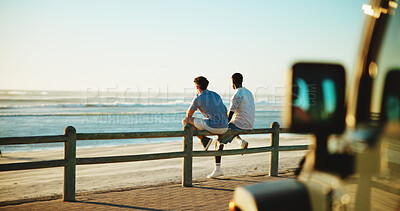 Buy stock photo Men, back and friends at beach for break with bonding, space and support outdoor. Sunset, road trip and people by wood fence, travel or vacation to relax with connection in nature with ocean view