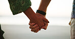 Holiday, closeup or couple holding hands at beach for vacation, anniversary or honeymoon. Paradise, care and romantic people bonding at sea together for outdoor travel, relationship or ocean trip