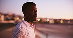 Sunset, thinking and beach with black man, travel and nature with memory, vacation and break. Seaside, summer holiday and happy person with reflection, decision and choice with peace and nostalgia