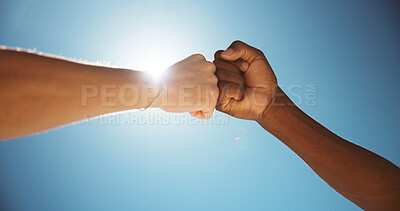 Buy stock photo People, fist bump and teamwork with blue sky for gratitude, appreciation or thank you in sunlight. Closeup, friends or touch with trust or lens flare below for commitment, greeting or agreement
