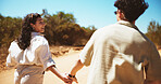 Holding hands, nature and couple on holiday, getaway or weekend trip in desert. Love, care and man with woman for walking in adventure, journey or vacation outdoor with romance together with travel.