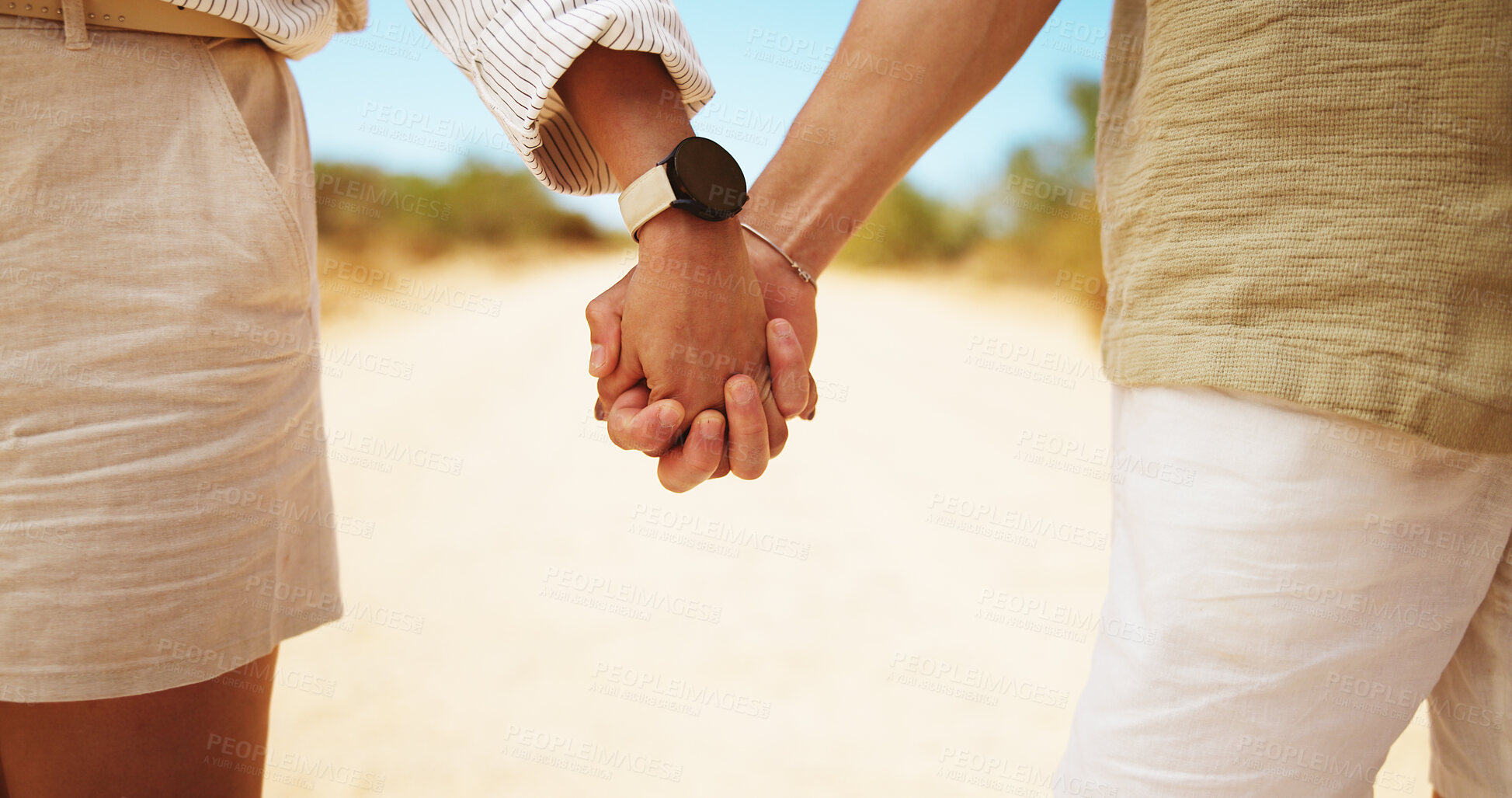 Buy stock photo Couple, holding hands and walking with partner for travel, journey or outdoor trip together in safari. Closeup, people or lovers with touch, commitment or support for trust, safety or security
